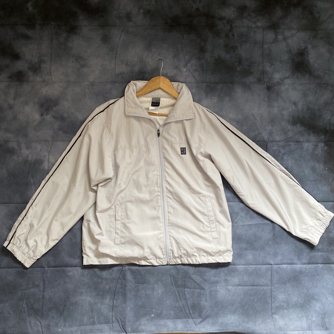 Vintage Nike White Track Jacket Windbreaker (Category: Coats, Jackets and Outerwear) located in Manila. Submitted by seramisu (Listing ID 1467572279, Image 1). Description: - Authentic Nike track jacket in classic white with black side stripes - Size: XL - Features: Full zip closure, high collar, functional side pockets, and small embroidered logo patch on left chest - Perfect for sporty casual wear or workouts - Modesty/Authenticity guaranteed, 