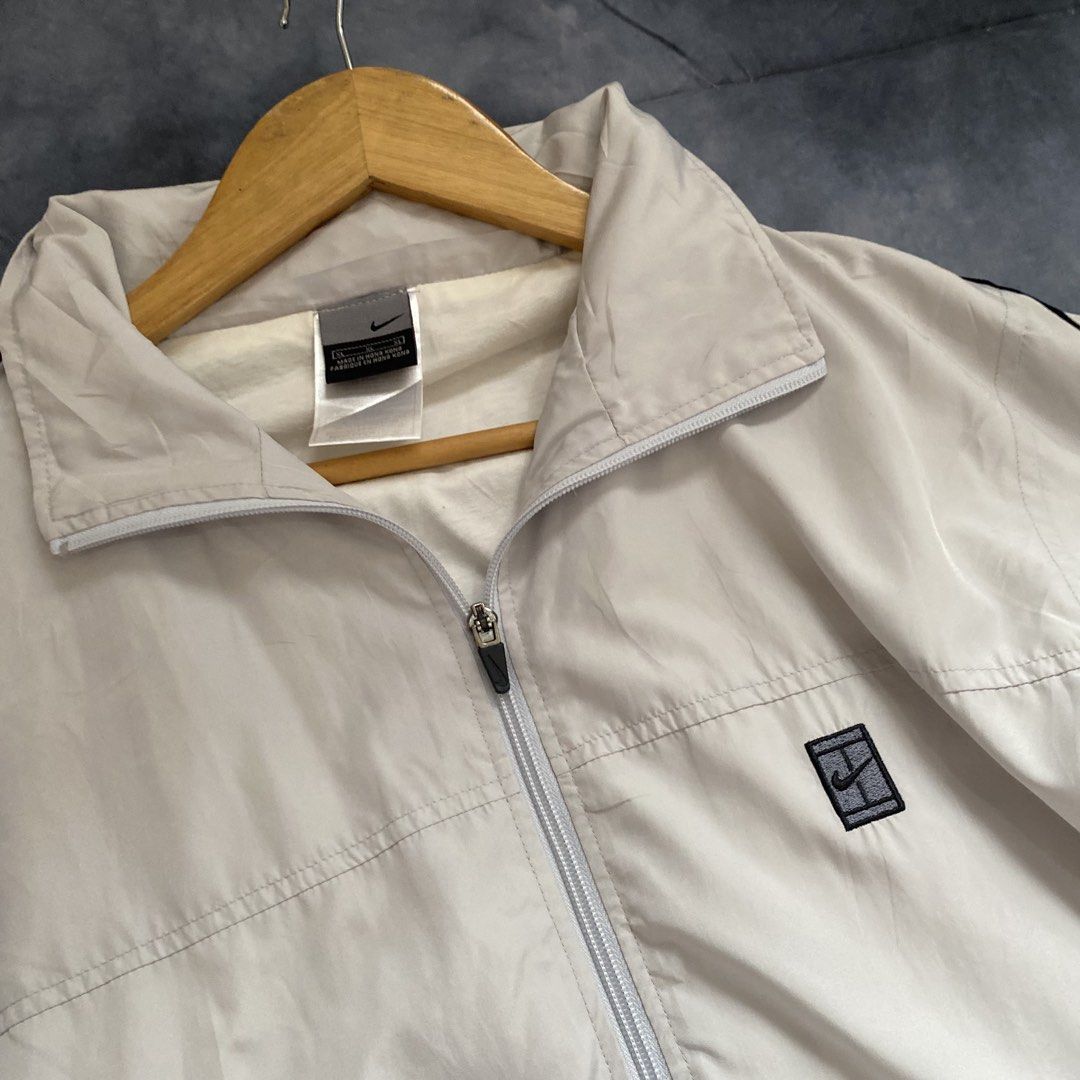 Vintage Nike White Track Jacket Windbreaker (Category: Coats, Jackets and Outerwear) located in Manila. Submitted by seramisu (Listing ID 1467572279, Image 2). Description: - Authentic Nike track jacket in classic white with black side stripes - Size: XL - Features: Full zip closure, high collar, functional side pockets, and small embroidered logo patch on left chest - Perfect for sporty casual wear or workouts - Modesty/Authenticity guaranteed, 
