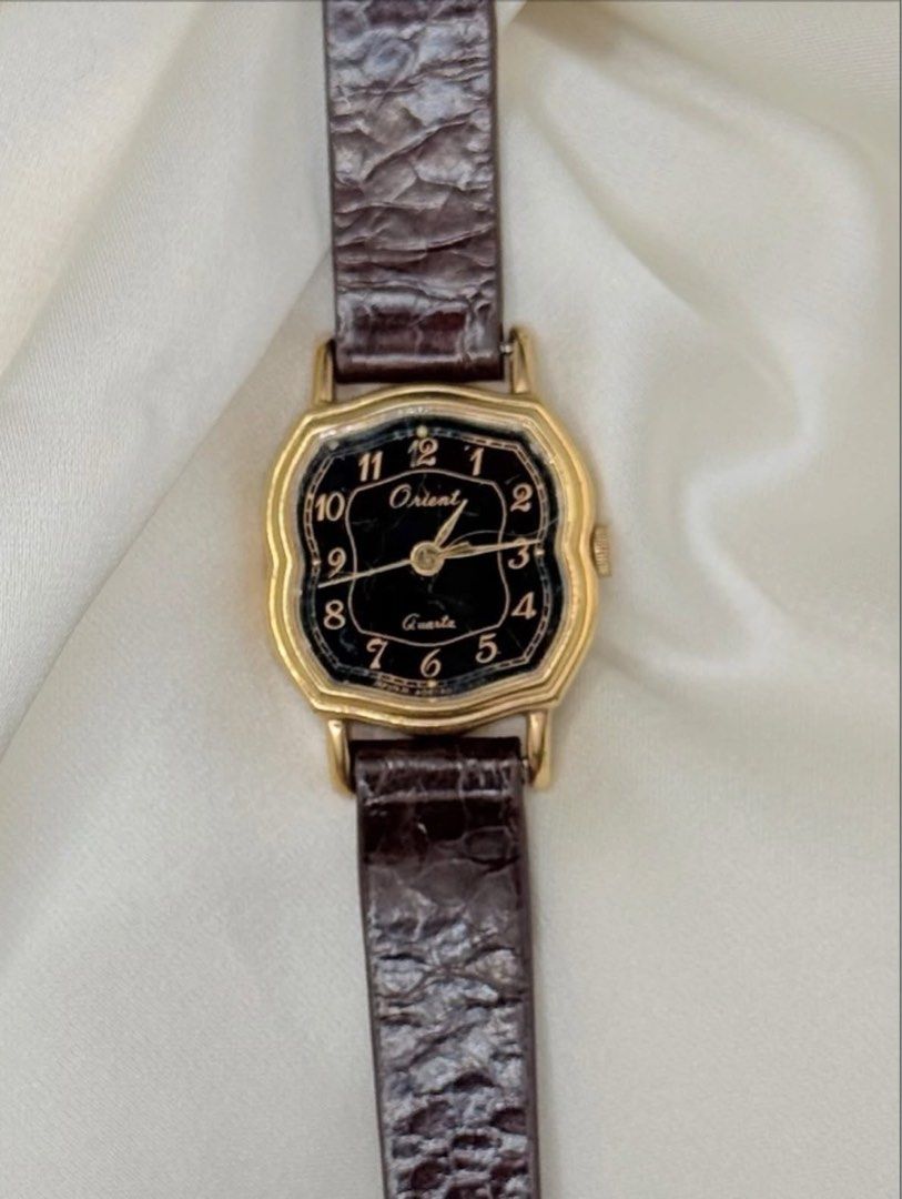 Vintage Orient Dainty Watch (Category: Women's Watches) located in Lipa City. Submitted by watchoutph (Listing ID 1467549290, Image 2). Description: Vintage Orient Small-Faced Watch (Rare) Black Dial octagonal cushion-shaped case with stepped bezel Quartz Arabic indices Gold case 19x20mm case Multiple scratches on glass For collectors ₱4,500.