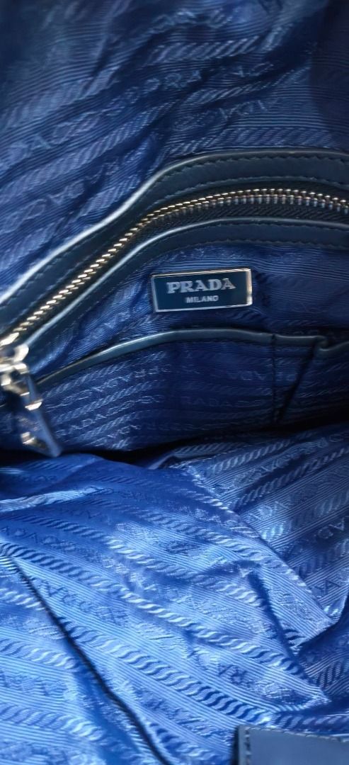 Vintage Prada Tessuto Nylon Bag (Category: Luxury Bags & Wallets) located in Batangas. Submitted by livefox.055486 (Listing ID 1467583458, Image 3). Description: Selling this Authentic Prada Tessuto Nylon & Webbing Tote Bag -Color: Navy Blue / Cream White Webbing Trim -Material: Tessuto Nylon with Saffiano Leather & Webbing Accents -Details: Silver-tone hardware, Lampo zipper, signature jacquard lining, internal zipped pocket. -Condition: Pre-lov