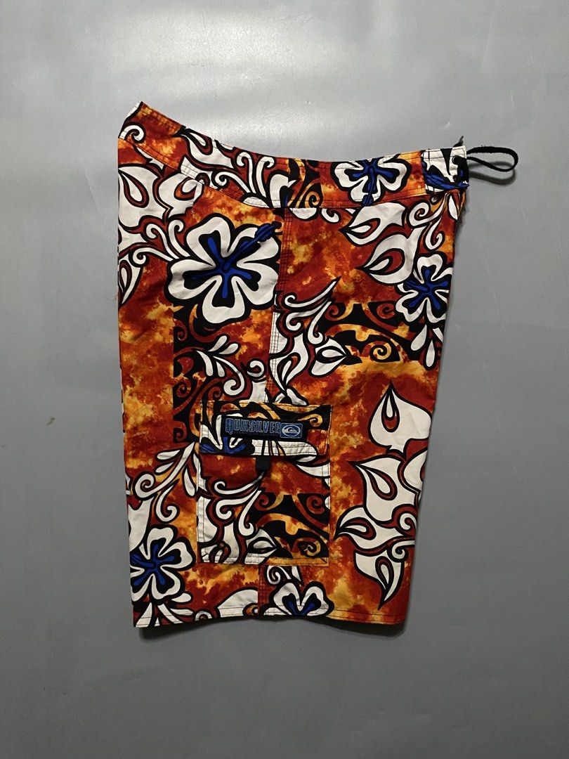 Vintage Quiksilver Board Shorts (Category: Swim Trunks & Board Shorts) located in Manila. Submitted by delunakenn94368 (Listing ID 1467509391, Image 3). Description: - Brand: Quiksilver - Size: 32 - Color/Design: Orange, black, and white floral print - Features: Side cargo pocket with branded patch, secure drawstring waist - Style: Classic surf style, vibrant and eye-catching.