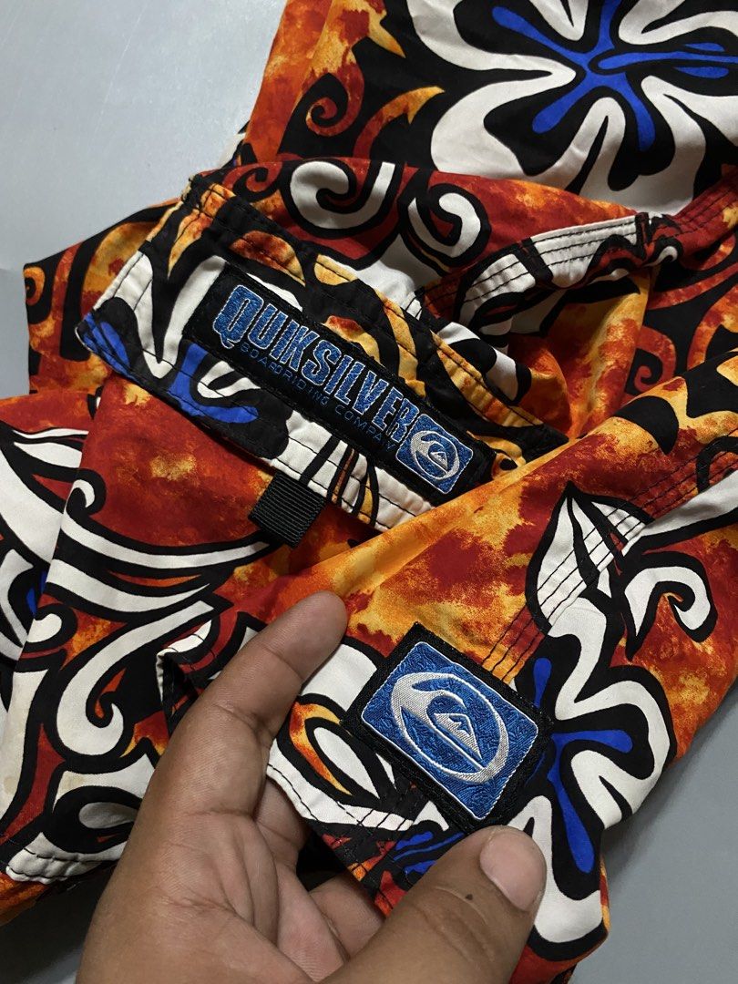 Vintage Quiksilver Board Shorts (Category: Swim Trunks & Board Shorts) located in Manila. Submitted by delunakenn94368 (Listing ID 1467509391, Image 2). Description: - Brand: Quiksilver - Size: 32 - Color/Design: Orange, black, and white floral print - Features: Side cargo pocket with branded patch, secure drawstring waist - Style: Classic surf style, vibrant and eye-catching.