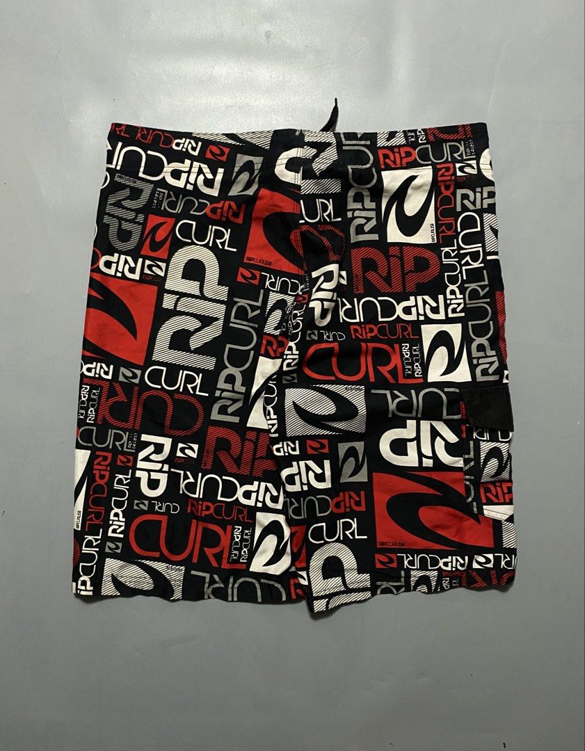 Vintage Rip Curl Board Shorts (Category: Swim Trunks & Board Shorts) located in Manila. Submitted by delunakenn94368 (Listing ID 1467509323, Image 2). Description: - Authentic Rip Curl board shorts - Striking all-over logo print in black, red, and white - Secure drawstring waistband with lace-up closure - Convenient side cargo pocket with button flap - Lightweight, quick-dry fabric ideal for surfing, swimming, and beach days - Refer to tag for ex