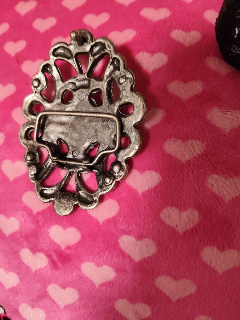 Vintage Style Silver Tone Scrollwork and Gem Belt Buckle (Category: Belts) located in Pasay City. Submitted by ynamariie (Listing ID 1467466886, Image 3). Description: - Vintage ornate silver-tone metal belt buckle - Features a striking oval grey center stone - Surrounded by smaller rhinestones in a floral scroll pattern - Dimensions: approx. 3 inches wide x 2.5 inches high - Standard pin and bar closure on the back - Good vintage condition with 