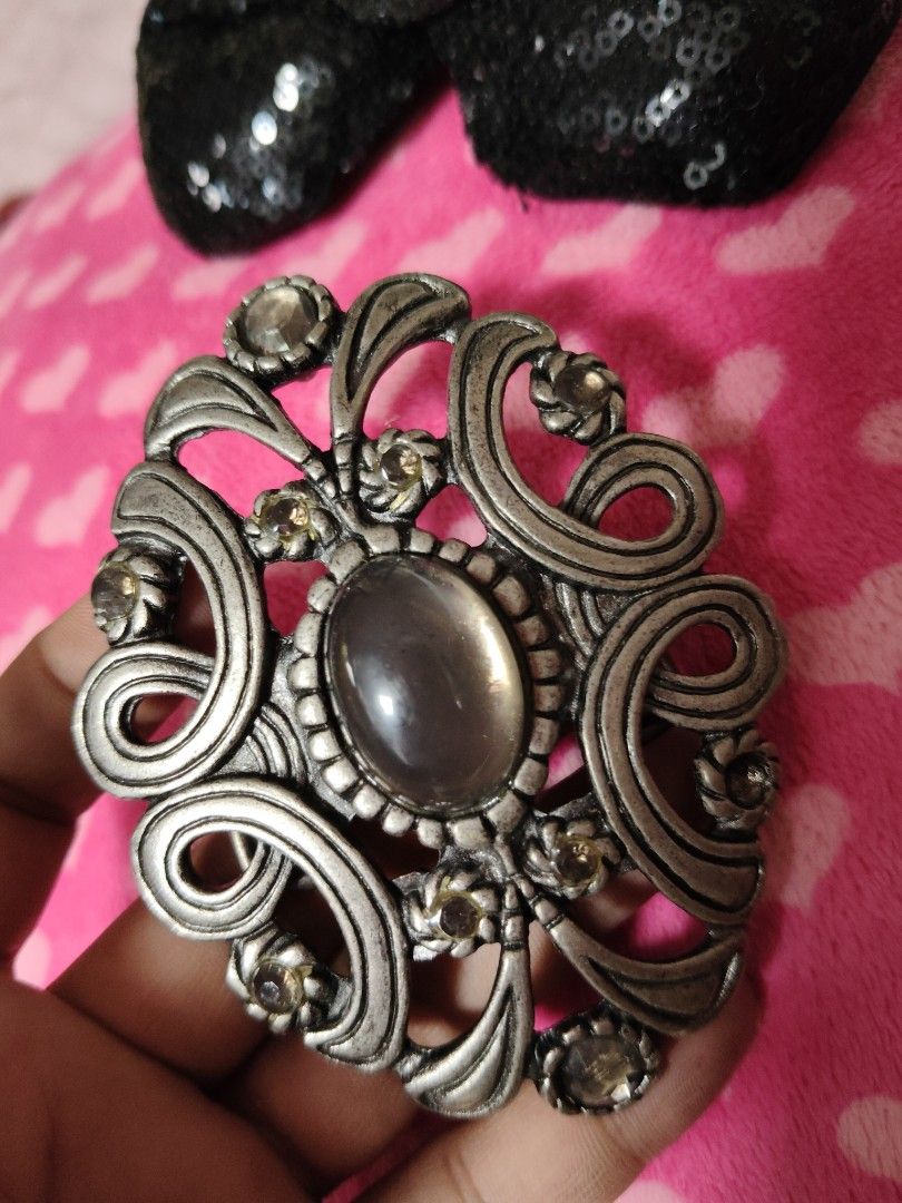 Vintage Style Silver Tone Scrollwork and Gem Belt Buckle (Category: Belts) located in Pasay City. Submitted by ynamariie (Listing ID 1467466886, Image 1). Description: - Vintage ornate silver-tone metal belt buckle - Features a striking oval grey center stone - Surrounded by smaller rhinestones in a floral scroll pattern - Dimensions: approx. 3 inches wide x 2.5 inches high - Standard pin and bar closure on the back - Good vintage condition with 