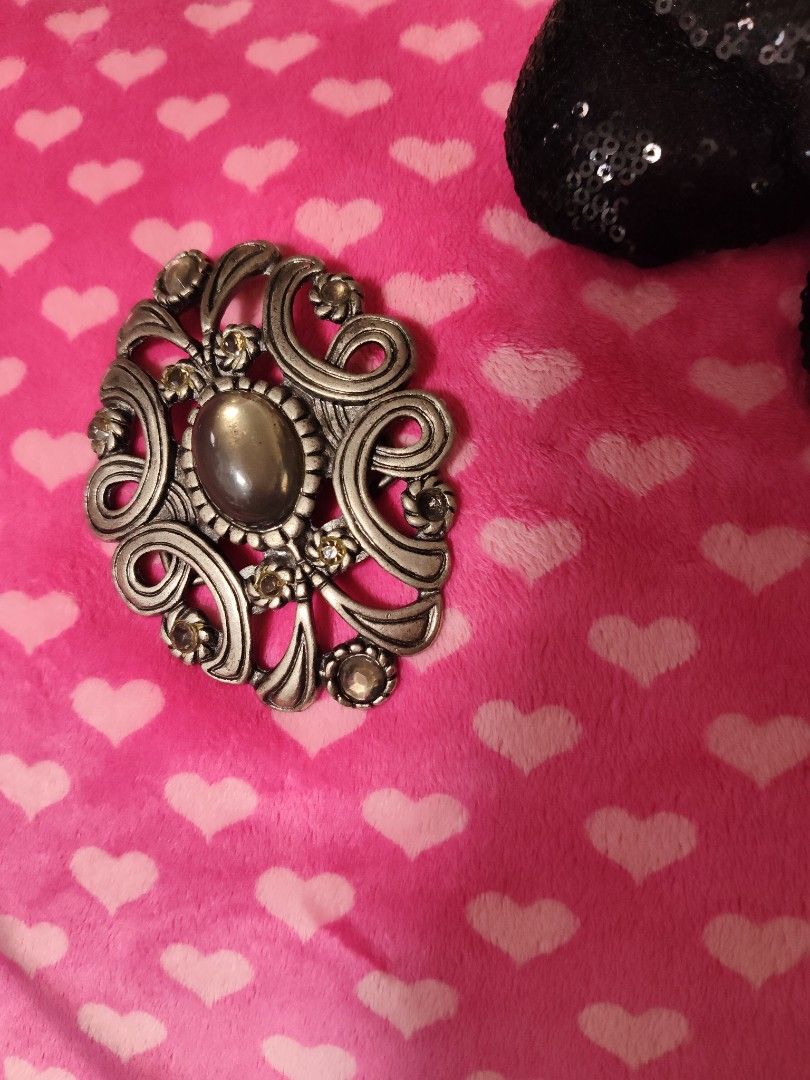 Vintage Style Silver Tone Scrollwork and Gem Belt Buckle (Category: Belts) located in Pasay City. Submitted by ynamariie (Listing ID 1467466886, Image 2). Description: - Vintage ornate silver-tone metal belt buckle - Features a striking oval grey center stone - Surrounded by smaller rhinestones in a floral scroll pattern - Dimensions: approx. 3 inches wide x 2.5 inches high - Standard pin and bar closure on the back - Good vintage condition with 