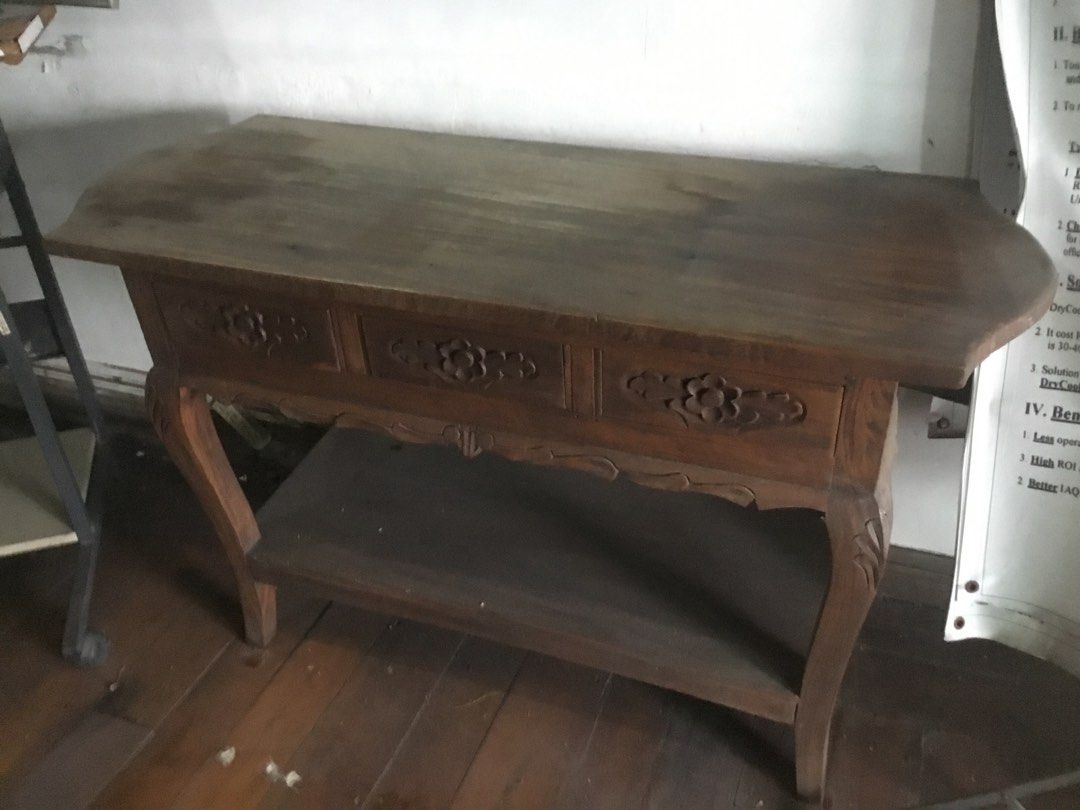 Vintage Wooden Console Table with Drawers (Category: Tables & Sets) located in Manila. Submitted by roberto.enriquez (Listing ID 1467589027, Image 2). Description: - Material: Premium solid wood with a rich dark brown finish - Storage: 3 front drawers with intricate floral carvings plus a lower shelf - Design: Classic rustic style with elegant curved cabriole legs - Placement: Ideal for entryways, hallways, or living spaces - Condition: Sturdy an