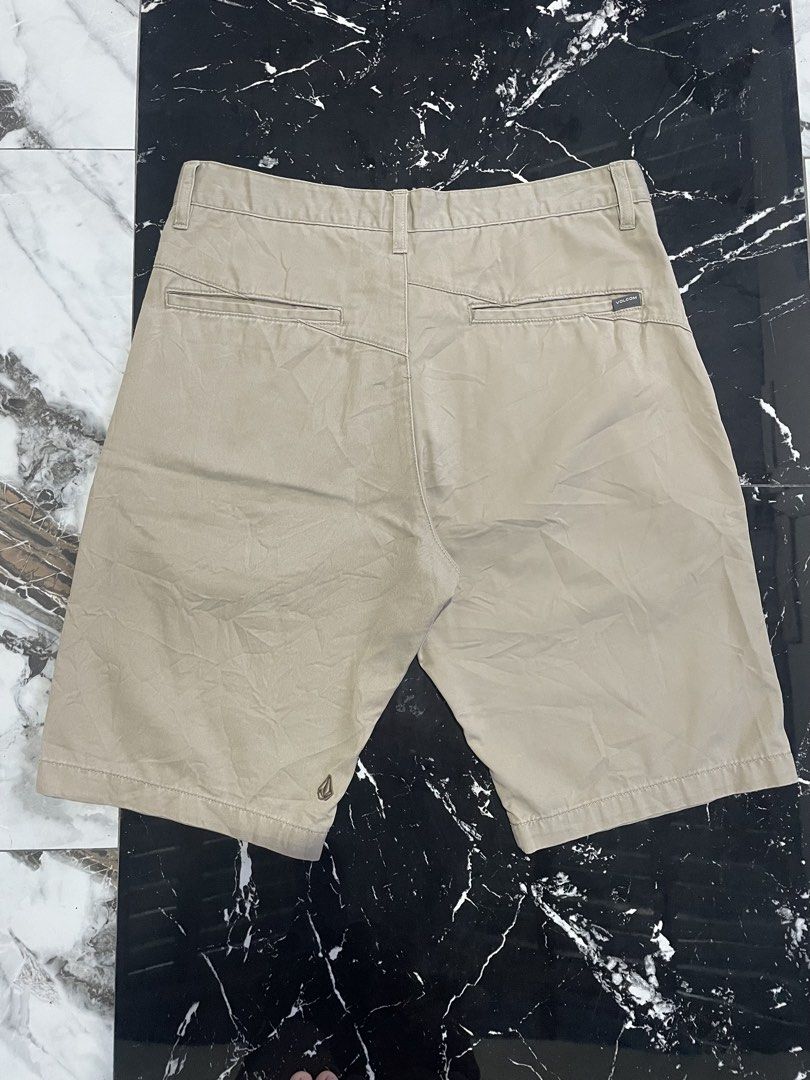 Volcom beige chino shorts (Category: Shorts) located in Catigbian. Submitted by ekong_yeager (Listing ID 1467442373, Image 2). Description: - Brand: Volcom - Color: Classic beige/khaki - Material: Durable twill fabric - Closure: Front button with engraved logo - Branding: Embroidered Volcom stone logo on left hem and back right pocket - Pockets: Dual rear welt pockets - Condition: Great casual wear piece for warmer days - Ships within the Philipp