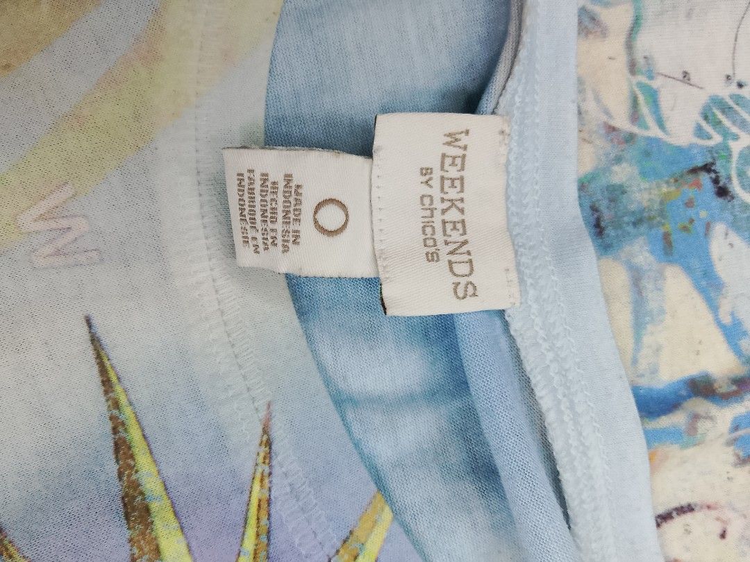 Weekends by Chico's Dolphin Graphic Tee Size 0 (Category: Shirts) located in Midsayap. Submitted by jarethshop (Listing ID 1467527149, Image 3). Description: - Brand: Weekends by Chico's - Size: 0 - Color: Light blue - Design: Colorful beach & marine graphic with dolphins, compass rose, and postal stamps - Style: Short sleeves, crew neck - Origin: Made in Indonesia - Condition: Excellent pre-loved condition.