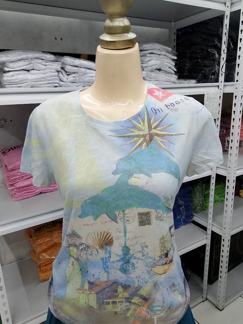 Weekends by Chico's Dolphin Graphic Tee Size 0 (Category: Shirts) located in Midsayap. Submitted by jarethshop (Listing ID 1467527149, Image 1). Description: - Brand: Weekends by Chico's - Size: 0 - Color: Light blue - Design: Colorful beach & marine graphic with dolphins, compass rose, and postal stamps - Style: Short sleeves, crew neck - Origin: Made in Indonesia - Condition: Excellent pre-loved condition.
