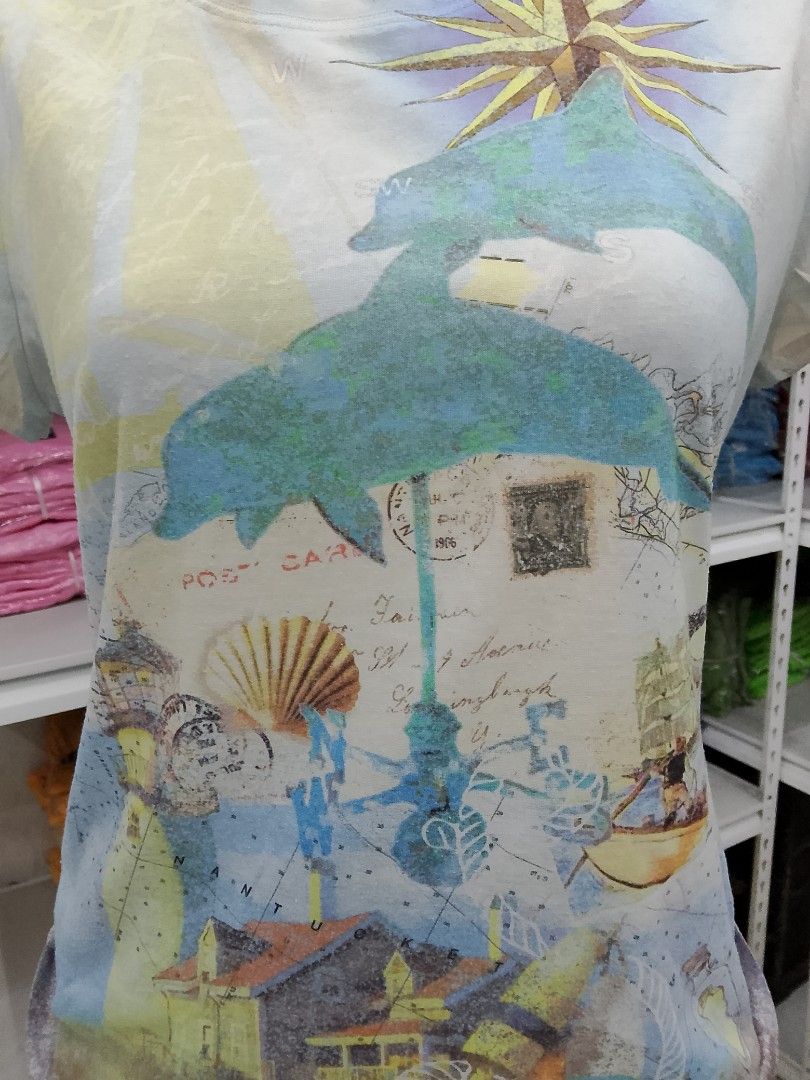 Weekends by Chico's Dolphin Graphic Tee Size 0 (Category: Shirts) located in Midsayap. Submitted by jarethshop (Listing ID 1467527149, Image 2). Description: - Brand: Weekends by Chico's - Size: 0 - Color: Light blue - Design: Colorful beach & marine graphic with dolphins, compass rose, and postal stamps - Style: Short sleeves, crew neck - Origin: Made in Indonesia - Condition: Excellent pre-loved condition.