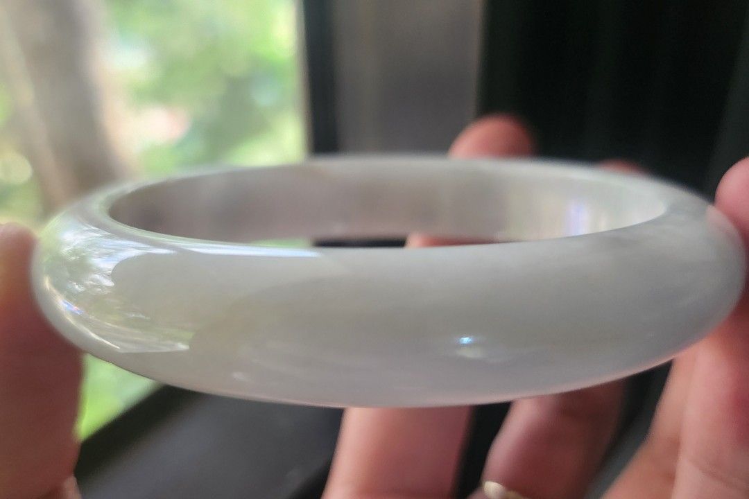 White Burmese Jadeite Bangle 60.4mm (Category: Bracelets) located in Baguio. Submitted by lausgem2026 (Listing ID 1467427414, Image 3). Description: -A white Burmese Jadeite Bangle with some sajin (sprinkled gold/yellow) and wuji (gray) colors. -Grade A (natural and untreated). -60.4mm diameter size. 12.4mm thickness. -Comes with a free box and free certificate. -Note: expect stonelines for its price range. -Location: Baguio City.