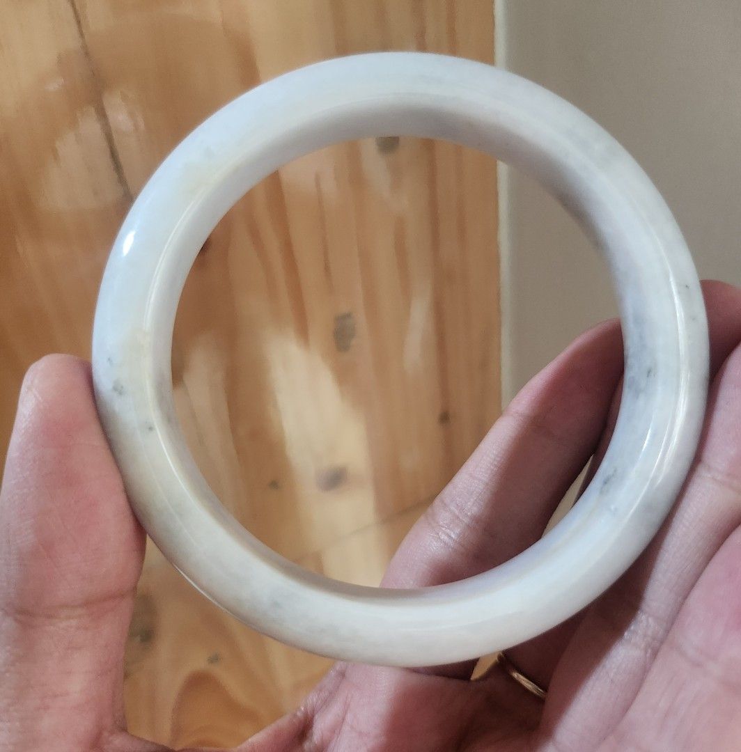 White Burmese Jadeite Bangle 60.4mm (Category: Bracelets) located in Baguio. Submitted by lausgem2026 (Listing ID 1467427414, Image 1). Description: -A white Burmese Jadeite Bangle with some sajin (sprinkled gold/yellow) and wuji (gray) colors. -Grade A (natural and untreated). -60.4mm diameter size. 12.4mm thickness. -Comes with a free box and free certificate. -Note: expect stonelines for its price range. -Location: Baguio City.