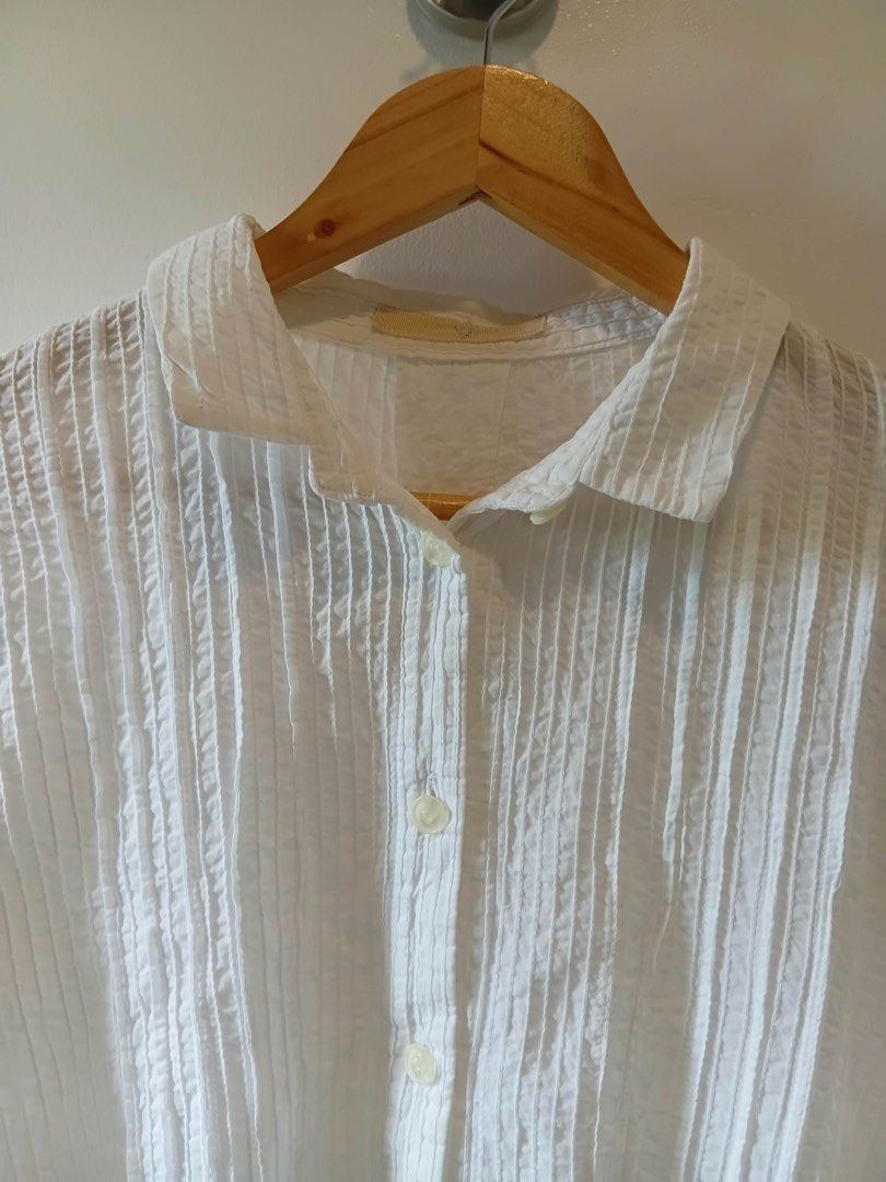 White button down shirt textured blouse size M to L (Category: Blouses) located in Antipolo. Submitted by wisecat.4a7eea (Listing ID 1467402954, Image 2). Description: - Color/Pattern: White with vertical textured stripes - Fit: Relaxed fit, comfortably fits Medium to Large frames - Details: Long sleeves, standard collar, button front closure - Fabric: Lightweight and breathable, perfect for layering or daily casual wear.