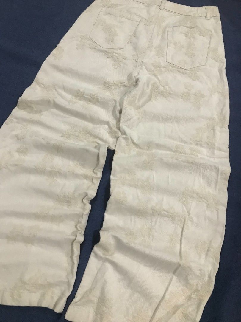 White floral textured wide leg pants (Category: Jeans) located in Manila. Submitted by its_d4ve (Listing ID 1467365014, Image 1). Description: - Color: White with all-over floral textured pattern - Fit: Relaxed through the legs for ultimate comfort - Features: Front button closure, belt loops, and two functional back pockets - Style: Versatile piece, great for casual everyday outfits - Condition: Brand new / Excellent quality.