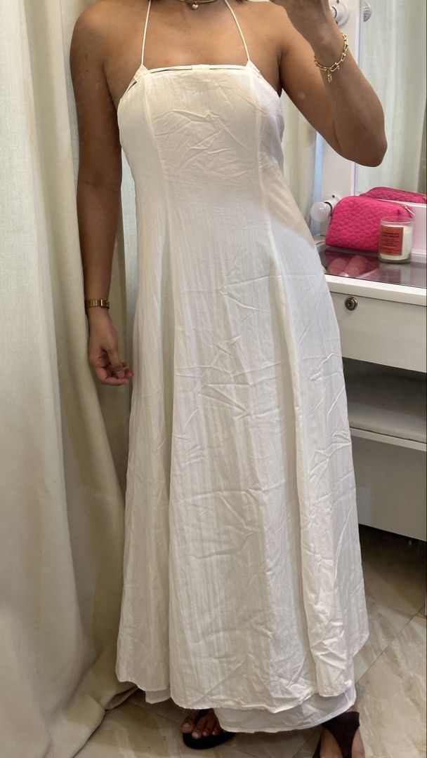White halter neck maxi dress with open back (Category: Dresses) located in Rizal. Submitted by literally.lori (Listing ID 1467435551, Image 2). Description: - Color: White - Style: Long maxi dress with an A-line cut and floor-length design - Features: Halter neck with tie-behind straps, low open back, and cute tassel tie details - Fabric: Lightweight and comfortable - Occasion: Ideal for beach trips, vacations, and summer outings - Condition: Cle