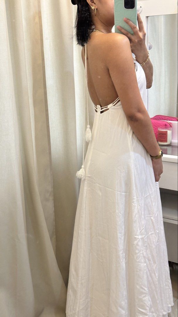 White halter neck maxi dress with open back (Category: Dresses) located in Rizal. Submitted by literally.lori (Listing ID 1467435551, Image 3). Description: - Color: White - Style: Long maxi dress with an A-line cut and floor-length design - Features: Halter neck with tie-behind straps, low open back, and cute tassel tie details - Fabric: Lightweight and comfortable - Occasion: Ideal for beach trips, vacations, and summer outings - Condition: Cle