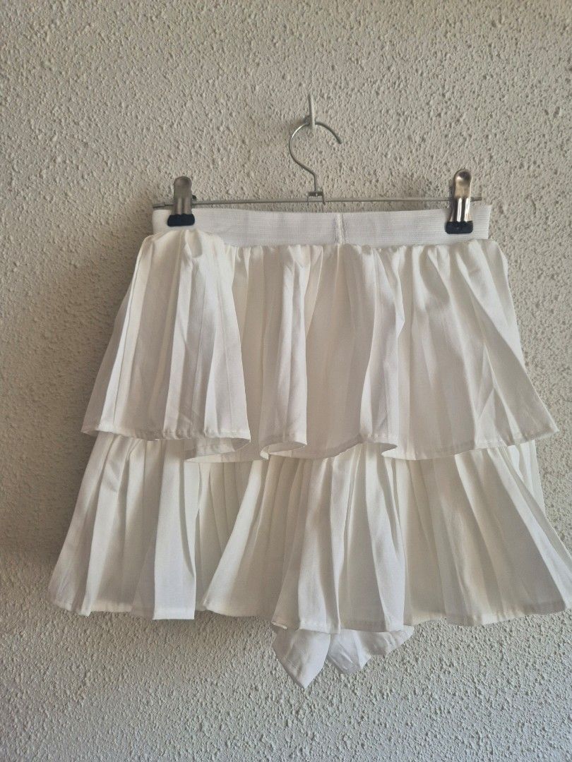 White Micro Skirt with Inner Shorts (Category: Skirts) located in Manila. Submitted by belovedbyjess (Listing ID 1467404901, Image 2). Description: - Color: White - Style: Layered pleated micro skirt with built-in inner shorts - Waist: 22 to 30 inches (Stretchy waistband) - Length: 12 inches - Fit: Best for XS to S frames (Can fit up to medium / 28-30 waistline, but will be quite tight) - Price: Php 450.