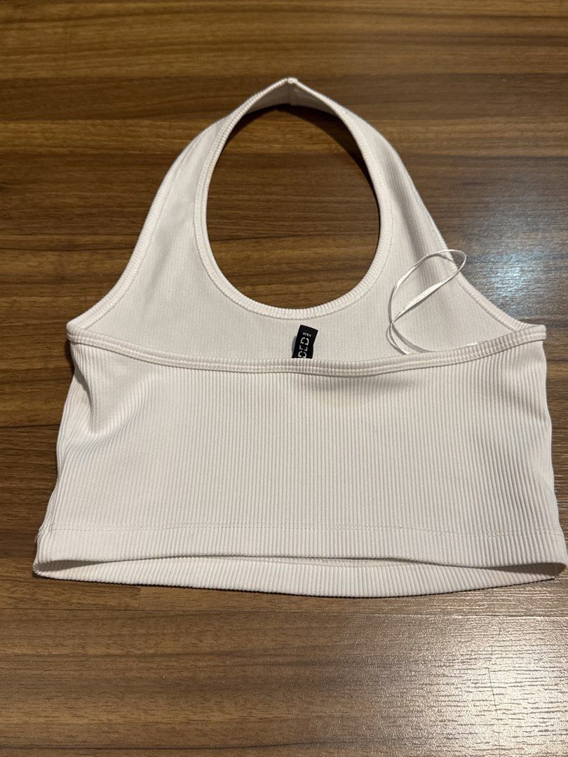 White Ribbed Halter Crop Top (Category: Sleeveless) located in Manila. Submitted by katrinakatee (Listing ID 1467498274, Image 2). Description: - Color: White - Style: Halter neck crop top - Material: Stretchy ribbed knit fabric - Fit: Snug, cropped length - Ideal for: Casual daily wear or pairing with high-waisted pants and skirts.