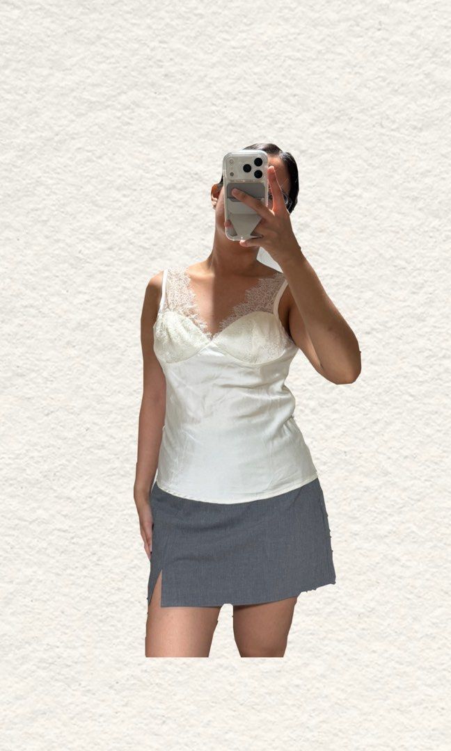 White Satin Tank Top with Lace Trim (Category: Sleeveless) located in Quezon City. Submitted by zealhorse_a9f3c3 (Listing ID 1465620155, Image 2). Description: - Color: Elegant white with a subtle sheen - Material: Soft, high-quality satin fabric - Design: V-neck cut with delicate lace detailing on cups and straps - Styling: Versatile piece, great for layering or wearing on its own - Condition: Excellent / Brand new.
