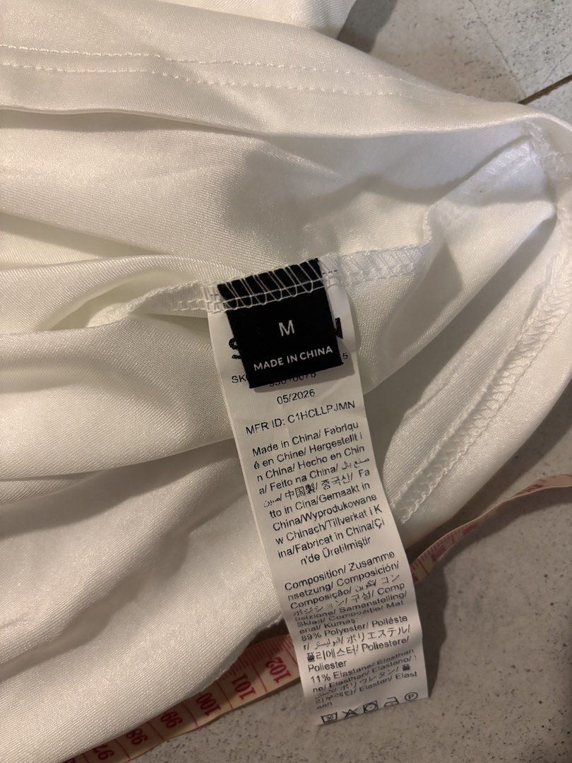 White silk top (Category: Shirts) located in Manila. Submitted by nicoleaaa (Listing ID 1467456623, Image 3). Description: - Color: Plain white - Size: M - Material: 89% polyester, 11% elastane (smooth with slight stretch) - Neckline: Standard crew neck - Details: Interior care and size tags attached - Origin: Made in China.