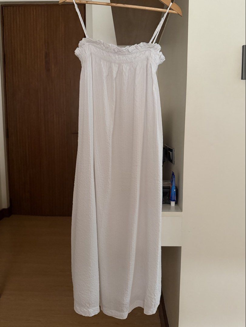 White Spaghetti Strap Long Dress Ruffle Neckline (Category: Dresses) located in Quezon City. Submitted by morgan_rysblk (Listing ID 1467391915, Image 1). Description: - Color: White - Style: Long maxi dress with thin spaghetti straps - Design: Ruffled neckline and textured fabric - Fit: Flowy, ankle-length - Easy to pair with sandals - Used once. Still very good quality.