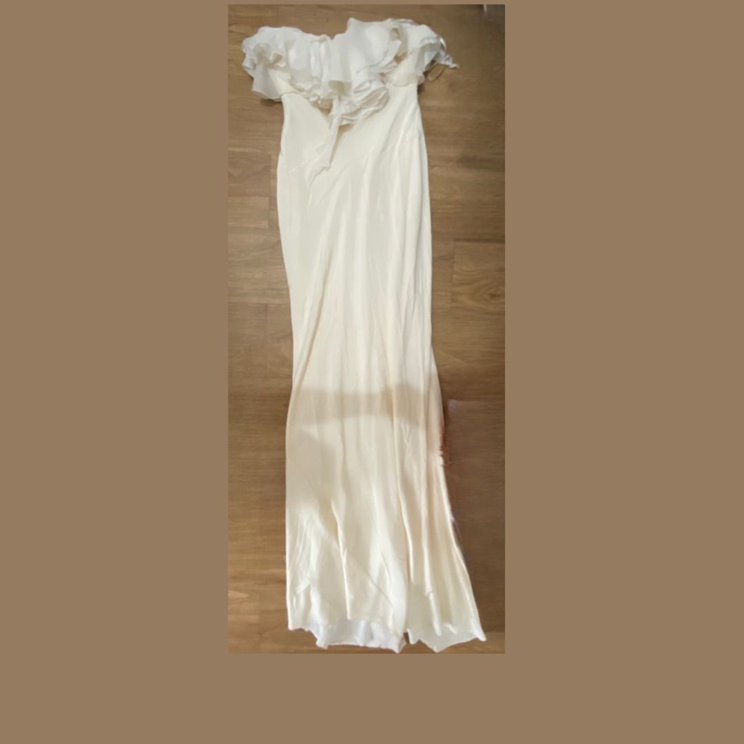 White Strapless Ruffle Evening Gown (Category: Dresses) located in Quezon City. Submitted by SustainableFashionatbp (Listing ID 1467532717, Image 1). Description: - Color: White - Style: Very elegant, Long, fitted silhouette strapless neckline completely framed by layered , fluid ruffles running horizontally across the chest - Length: Floor-length (60' from the chest) - Closure: Back zipper with small decorative covered buttons on the upper back 