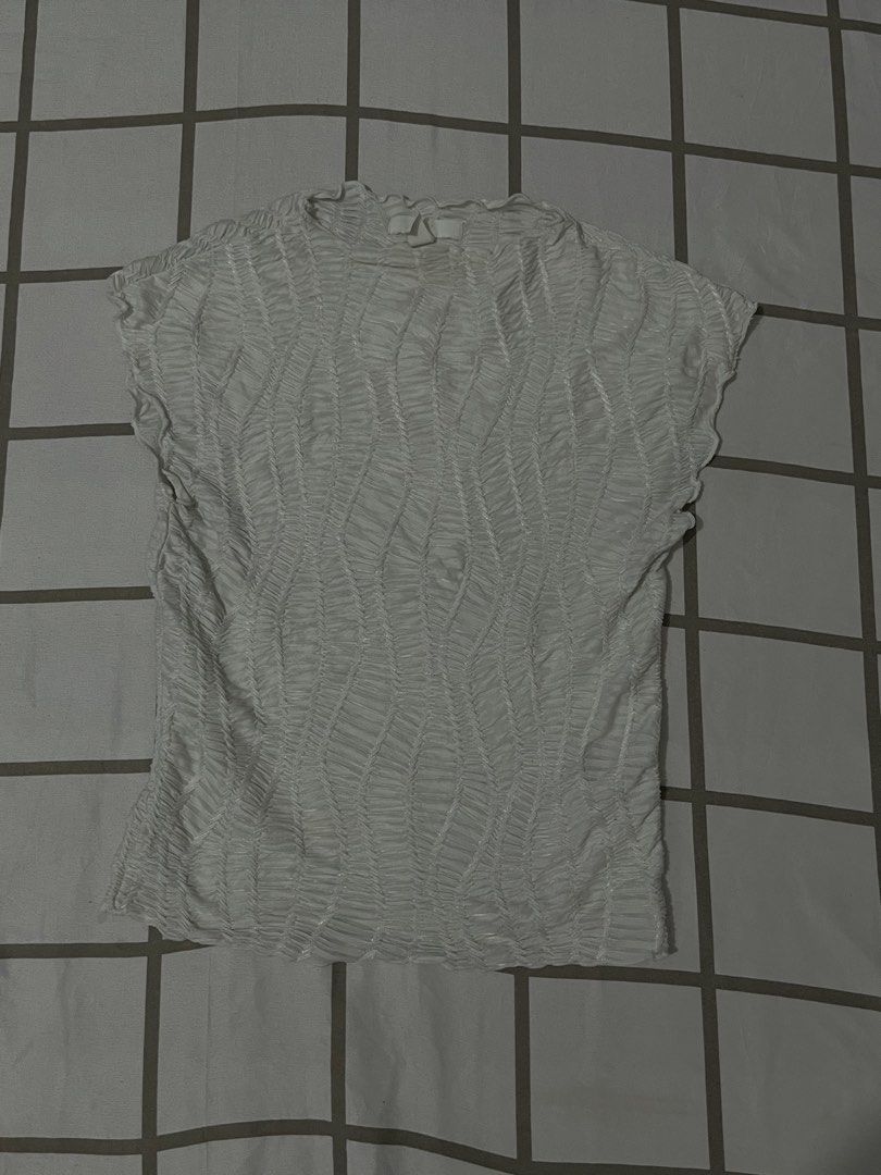 White textured crinkle short sleeve top (Category: Blouses) located in Angeles City. Submitted by silverearth_22153b (Listing ID 1467365640, Image 1). Description: - Color: White - Material: Stretch fabric with all-over crinkled texture - Design: Round neckline and cap sleeves - Fit: Form-fitting - Styling: Great basic piece for layering or wearing alone with jeans.