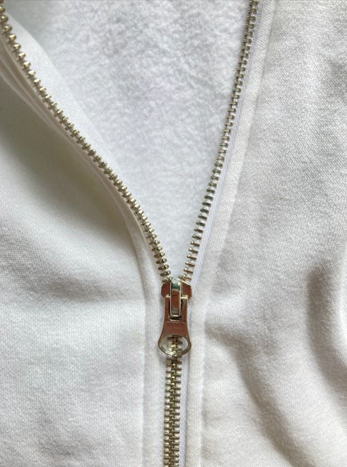 White Zip-Up Hoodie (Category: Coats, Jackets and Outerwear) located in Rizal. Submitted by sheeraay (Listing ID 1467465667, Image 2). Description: - Brand: H&M - Size: Medium (Regular fit) - Color: Clean White - Material: Cotton blend with soft fleece lining - Details: Silver-toned metal zipper, matching drawstrings with metal aglets, and double-layer hood.