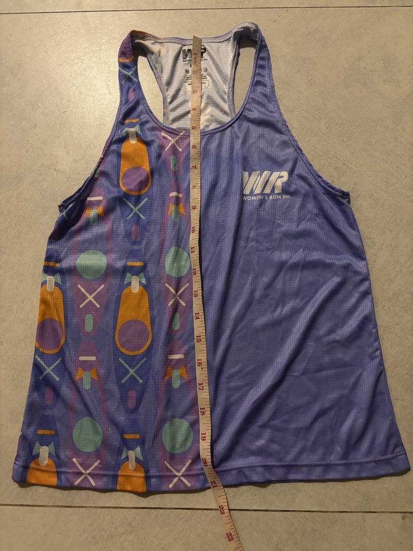 Women's Run CDO purple singlet (Small) (Category: Activewear) located in Manila. Submitted by nicoleaaa (Listing ID 1467452341, Image 2). Description: - Brand: Women's Run PH - Size: Small (Pit-to-pit: ~16", Length: ~23") - Color: Purple with colorful geometric canoe and paddle graphic - Design: Large vertical 'WOMEN'S RUN PH' back branding and racerback cut - Material: Lightweight athletic fabric, perfect for running and workouts - Condition: Ex