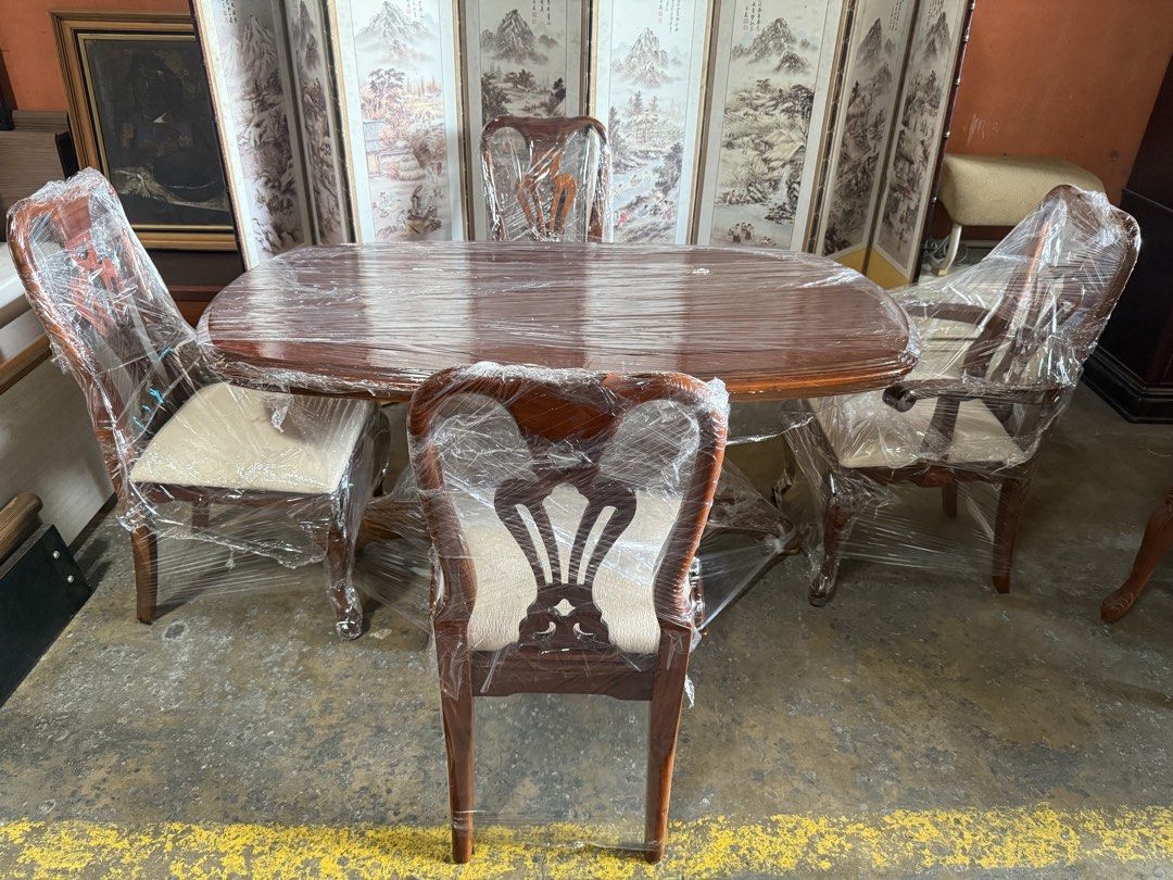 Wooden Dining Table Set with 4 Chairs (Category: Tables & Sets) located in Angeles City. Submitted by maryannmar33098 (Listing ID 1467516184, Image 1). Description: - Complete Set: Includes 1 oval dining table and 4 matching chairs - Sturdy Design: Features a solid wooden pedestal base on the table - Comfort: Chairs come with upholstered padded seats in an elegant light cream fabric - Aesthetic: Beautifully carved wooden backrests for a classic l