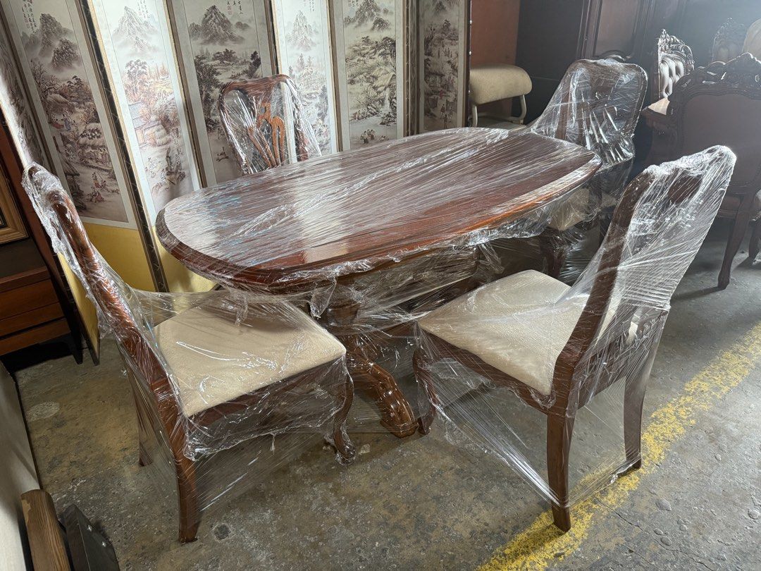Wooden Dining Table Set with 4 Chairs (Category: Tables & Sets) located in Angeles City. Submitted by maryannmar33098 (Listing ID 1467516184, Image 3). Description: - Complete Set: Includes 1 oval dining table and 4 matching chairs - Sturdy Design: Features a solid wooden pedestal base on the table - Comfort: Chairs come with upholstered padded seats in an elegant light cream fabric - Aesthetic: Beautifully carved wooden backrests for a classic l