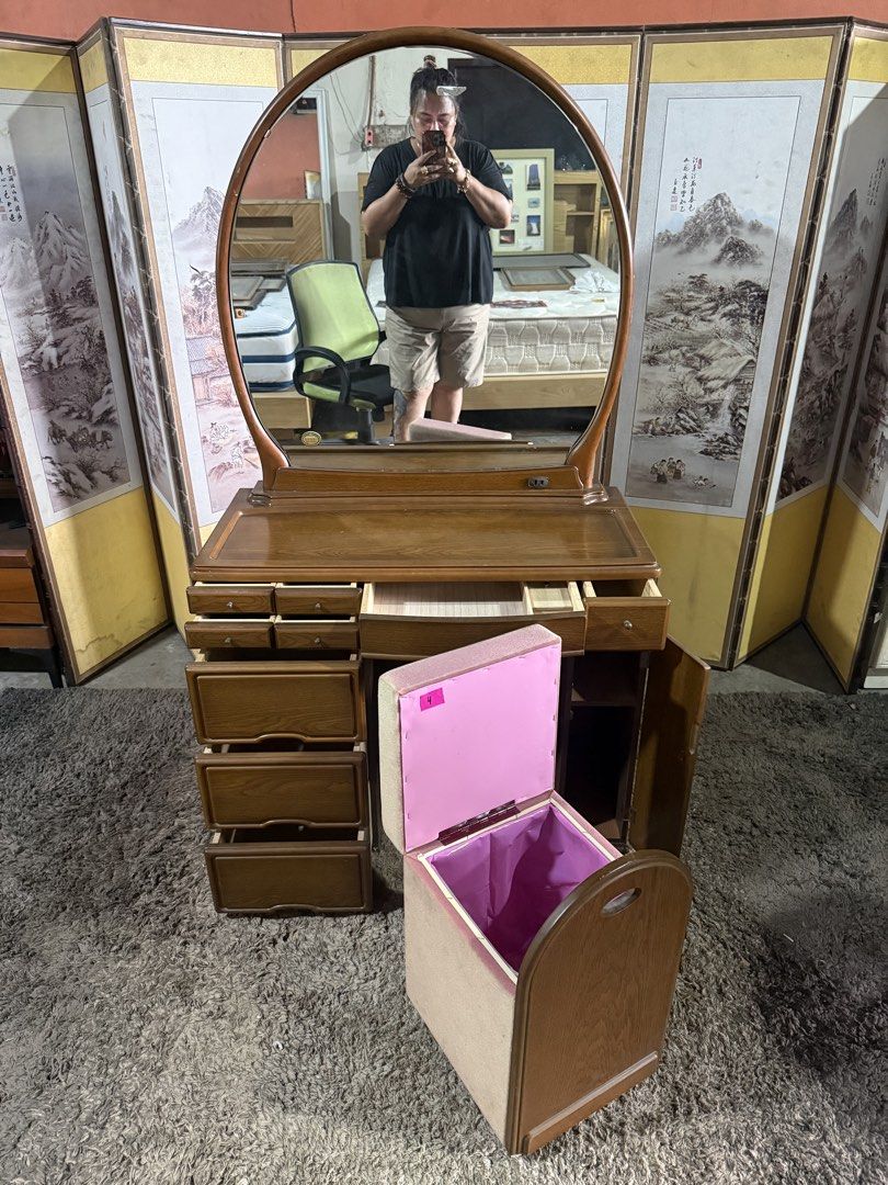 Wooden Vanity Table With Oval Mirror And Storage Stool (Category: Tables & Sets) located in Angeles City. Submitted by maryannmar33098 (Listing ID 1467513500, Image 2). Description: Wooden vanity set with a large oval mirror. Plenty of storage space here: six small drawers up top, three deep drawers on the left, a side cabinet, plus a matching storage stool with a lift-up seat lined in pink. Rich wood grain finish throughout. Built-in outlet on t