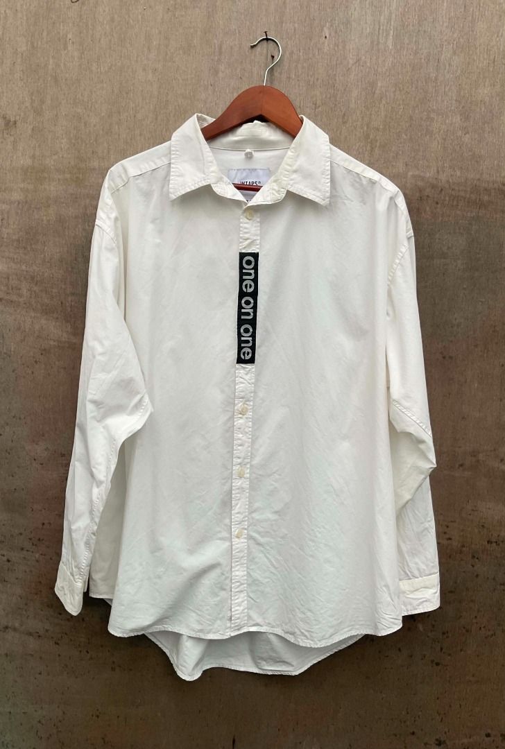 WTAPS x UNDERCOVER collaboration white button-down shirt (Category: Tshirts & Polo Shirts ) located in Talisay. Submitted by justindanielle17 (Listing ID 1467456894, Image 2). Description: -Authentic -25 inches width -30 inches length -Excellent Condition -9.8/10 color rate - Brand: WTAPS x UNDERCOVER - Color: Clean White - Size: XL / 04 (Marked on collar tag) - Material: 100% Cotton, Made in Japan - Details: WTAPS engraved branded buttons, black