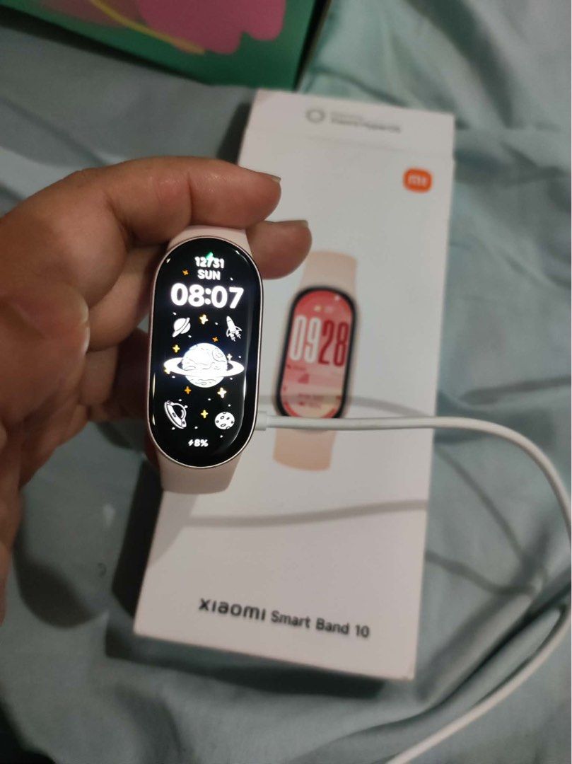 Xiaomi Smart Band 10 (Category: Wearables & Smart Watches) located in Quezon City. Submitted by crlpd (Listing ID 1467568603, Image 3). Description: - Brand: Xiaomi Smart Band 10 - Color: Pink strap with rose gold casing - Condition: Excellent, complete with original box and charging cable - OS: Powered by Xiaomi HyperOS - Key Features: 150+ sports modes, all-around health monitoring, 5ATM water resistance, and multiple band faces.