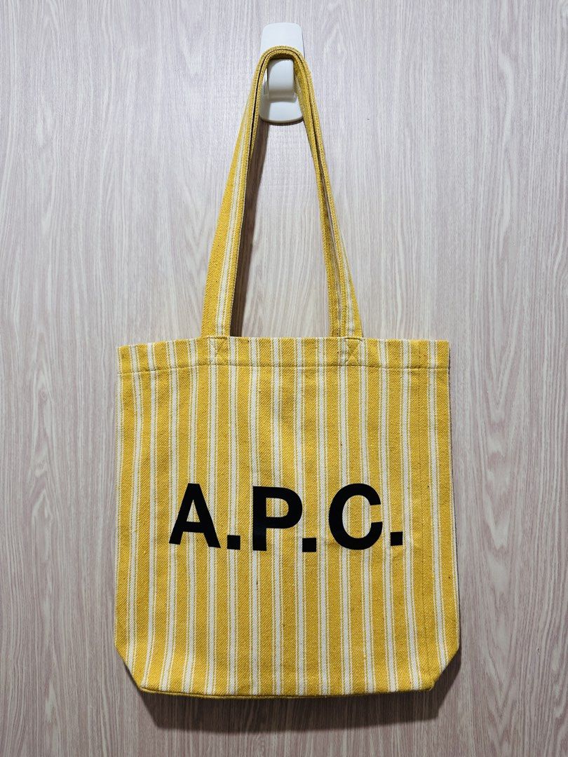 Yellow Stripe APC Tote Bag (Category: Tote Bags) located in Quezon City. Submitted by mikemofu (Listing ID 1466962450, Image 1). Description: Authentic APC Canvas material and natural color (inner is same white and yellow color) Rare seasonal item Unisex.