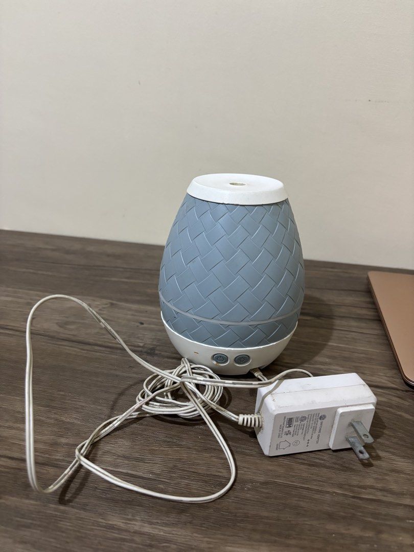 Young Living Desert Mist Essential Oil Diffuser (Category: Home Fragrance) located in Balayan. Submitted by authenticfindsbymrb (Listing ID 1467442734, Image 1). Description: - Authentic Young Living ultrasonic essential oil diffuser - Stylish gray basketweave pattern texture - Includes original power adapter and power cord - Fully functional, tested power and light control buttons - Exterior has minor scuff marks and stains - Interior water rese