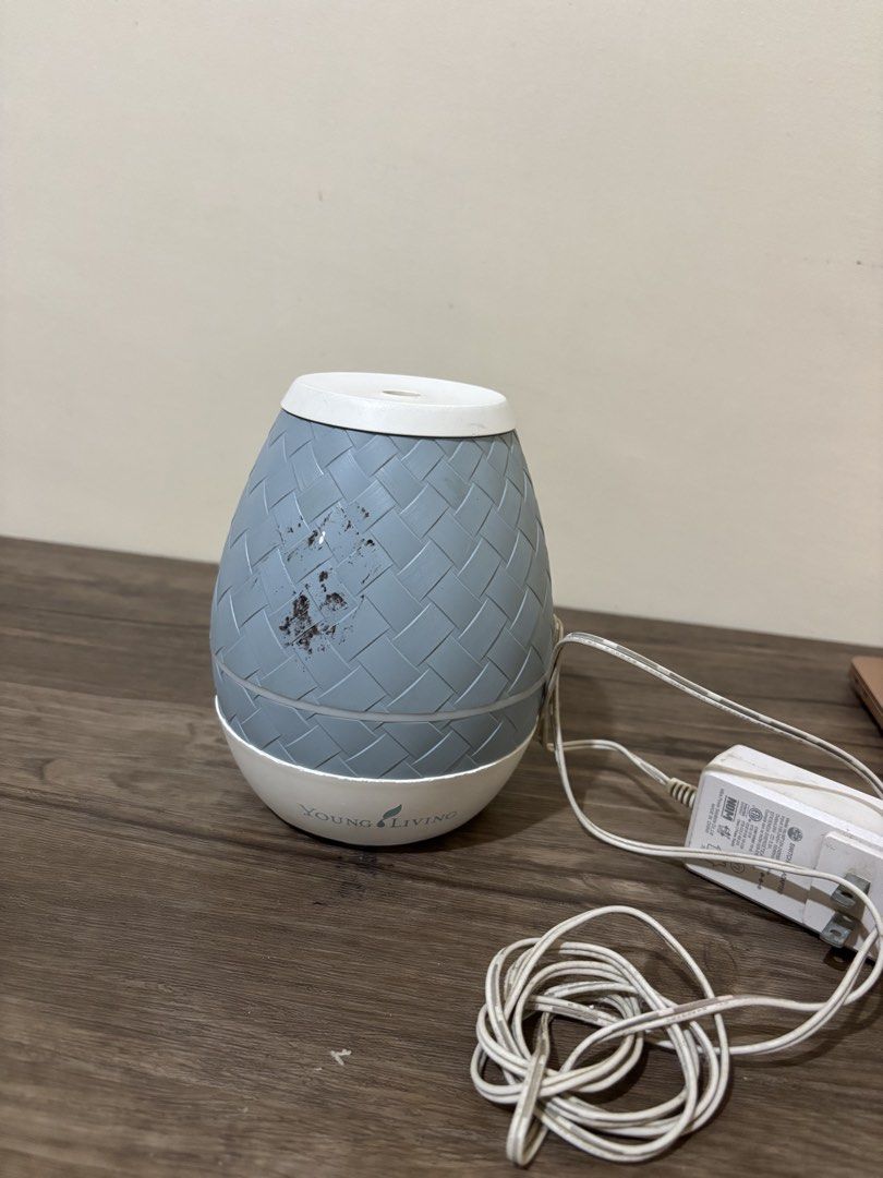 Young Living Desert Mist Essential Oil Diffuser (Category: Home Fragrance) located in Balayan. Submitted by authenticfindsbymrb (Listing ID 1467442734, Image 3). Description: - Authentic Young Living ultrasonic essential oil diffuser - Stylish gray basketweave pattern texture - Includes original power adapter and power cord - Fully functional, tested power and light control buttons - Exterior has minor scuff marks and stains - Interior water rese