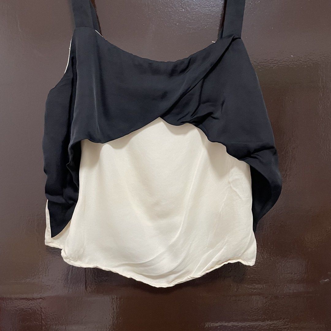 Zara Basic Collection Black and White Camisole Top XS (Category: Sleeveless) located in Pasay City. Submitted by lovedbyzea (Listing ID 1467526119, Image 2). Description: - Brand: Zara Basic Collection - Size: XS - Color: Black and white - Origin: Made in Turkey - Design: Double layered with a black twisted overlay and off-white inner layer - Straps: Adjustable thick straps - Style: Great contrast piece for casual outings or layering.