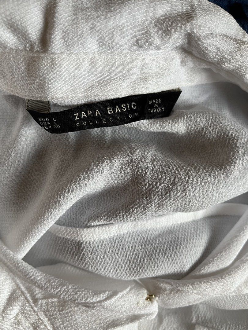 Zara Basic White Long Sleeve Button Down Shirt Size L (Category: Longsleeves) located in Tandag. Submitted by maryarlale42144 (Listing ID 1467367645, Image 3). Description: - Brand: Zara Basic - Size: L (EUR, USA, MEX) - Color: Classic White - Material: Lightweight textured fabric (slightly sheer) - Features: Classic collar, long sleeves with button cuffs, two front chest pockets, relaxed fit, curved hem with side slits - Origin: Made in Turkey -