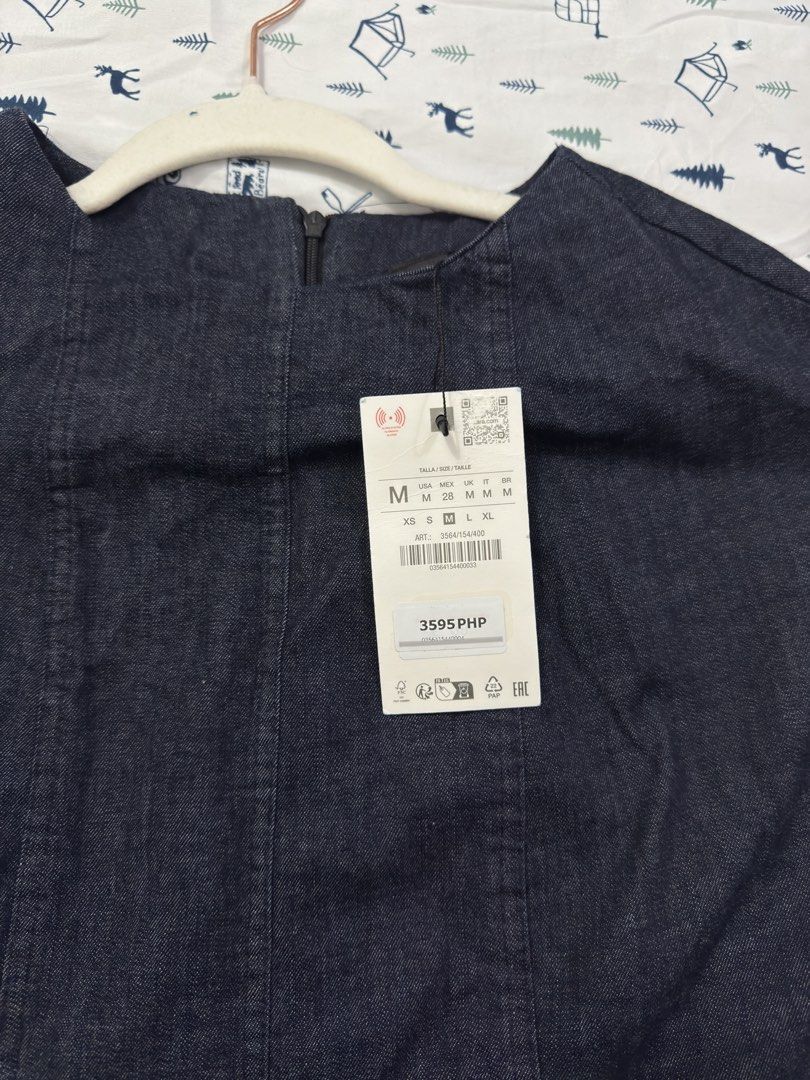 Zara Denim Midi Dress Size M missing belt (Category: Dresses) located in Manila. Submitted by janelica220598 (Listing ID 1467409478, Image 3). Description: - Brand: Zara - Style: Dark wash denim midi dress - Size: Medium (M) - Details: Short cap sleeves, structured panel stitching on front and back, back zipper closure - Condition: Brand new with original store tag attached (PHP 3,595).