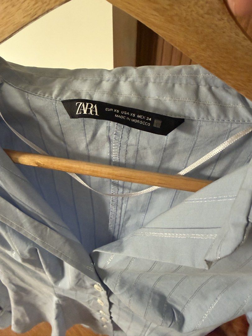 Zara Metallic Thread Striped Fitted Shirt (Category: Shirts) located in Quezon City. Submitted by morgan_rysblk (Listing ID 1467367738, Image 2). Description: - Brand: Zara - Color: Light blue with vertical metallic thread stripes - Size: XS - Love this! Too small na for me - Used once for school travel.