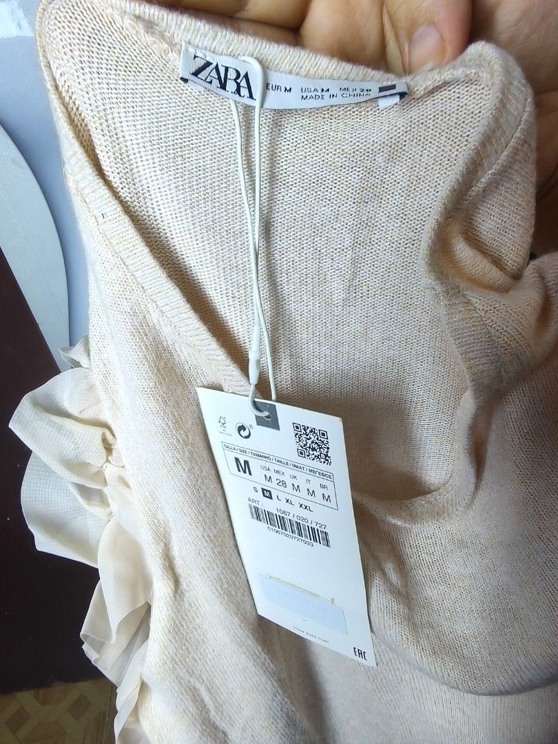 Zara Ruffled Sleeve Knit Top (Category: Blouses) located in Manila. Submitted by ashie_clothing (Listing ID 1467179461, Image 3). Description: - Brand: Zara - Style: Knit top with layered sheer tulle ruffles on short sleeves - Color: Beige melange - Neckline: Round neckline - Size: M - Condition: Brand new with tags (BNWT), never worn.
