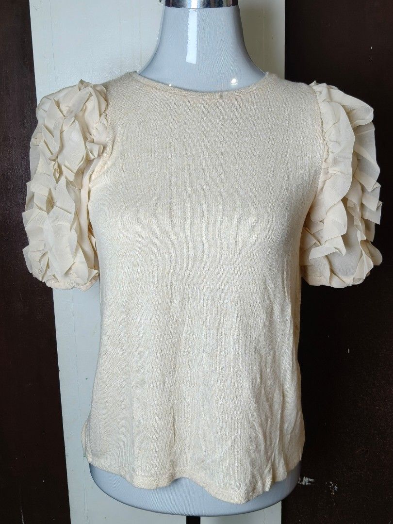 Zara Ruffled Sleeve Knit Top (Category: Blouses) located in Manila. Submitted by ashie_clothing (Listing ID 1467179461, Image 1). Description: - Brand: Zara - Style: Knit top with layered sheer tulle ruffles on short sleeves - Color: Beige melange - Neckline: Round neckline - Size: M - Condition: Brand new with tags (BNWT), never worn.