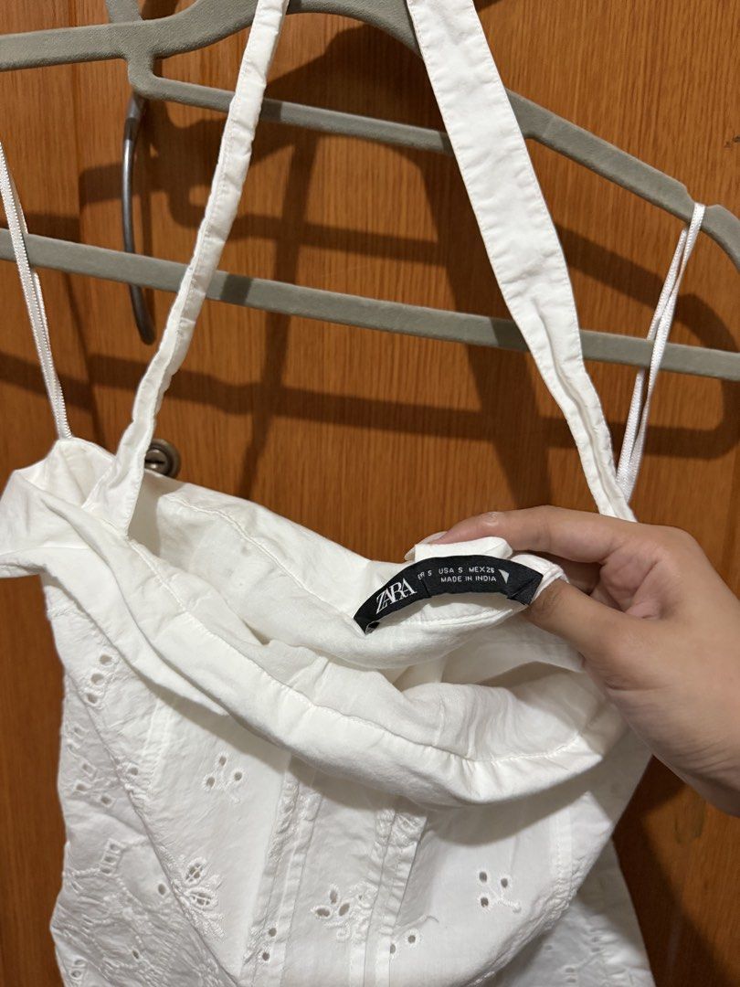 Zara White Eyelet Halter Top Size S (Category: Sleeveless) located in Muntinlupa City. Submitted by biancaagbscloset (Listing ID 1467514505, Image 2). Description: - Brand/Model: Zara White Eyelet Halter Top - Size: Small (S) - Material: Lightweight cotton, ideal for warm weather - Design: Delicate all-over floral cutwork embroidery, foldover neckline, and thin halter straps - Condition: Worn a couple of times, very good shape, clean, and ready t