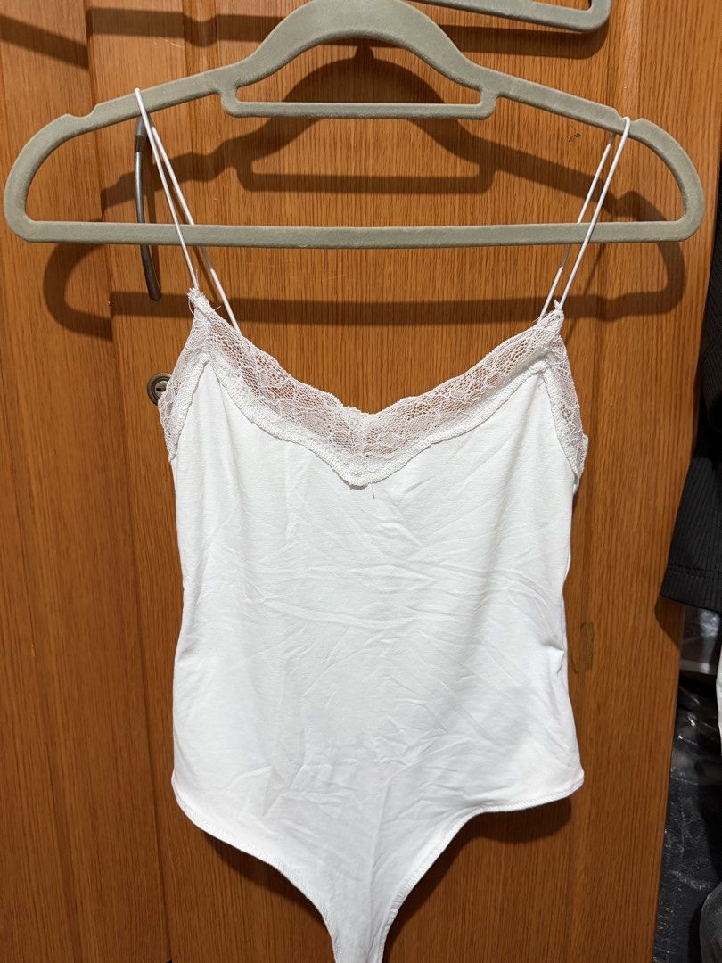 Zara White Lace Trim Bodysuit Size S (Category: Sleeveless) located in Muntinlupa City. Submitted by biancaagbscloset (Listing ID 1467514630, Image 1). Description: - Brand: Zara - Color: White - Material/Origin: Made in Turkey - Features: Delicate lace trim V-neck, thin adjustable spaghetti straps, bottom snap closure - Condition: Clean, great shape, and ready to wear.