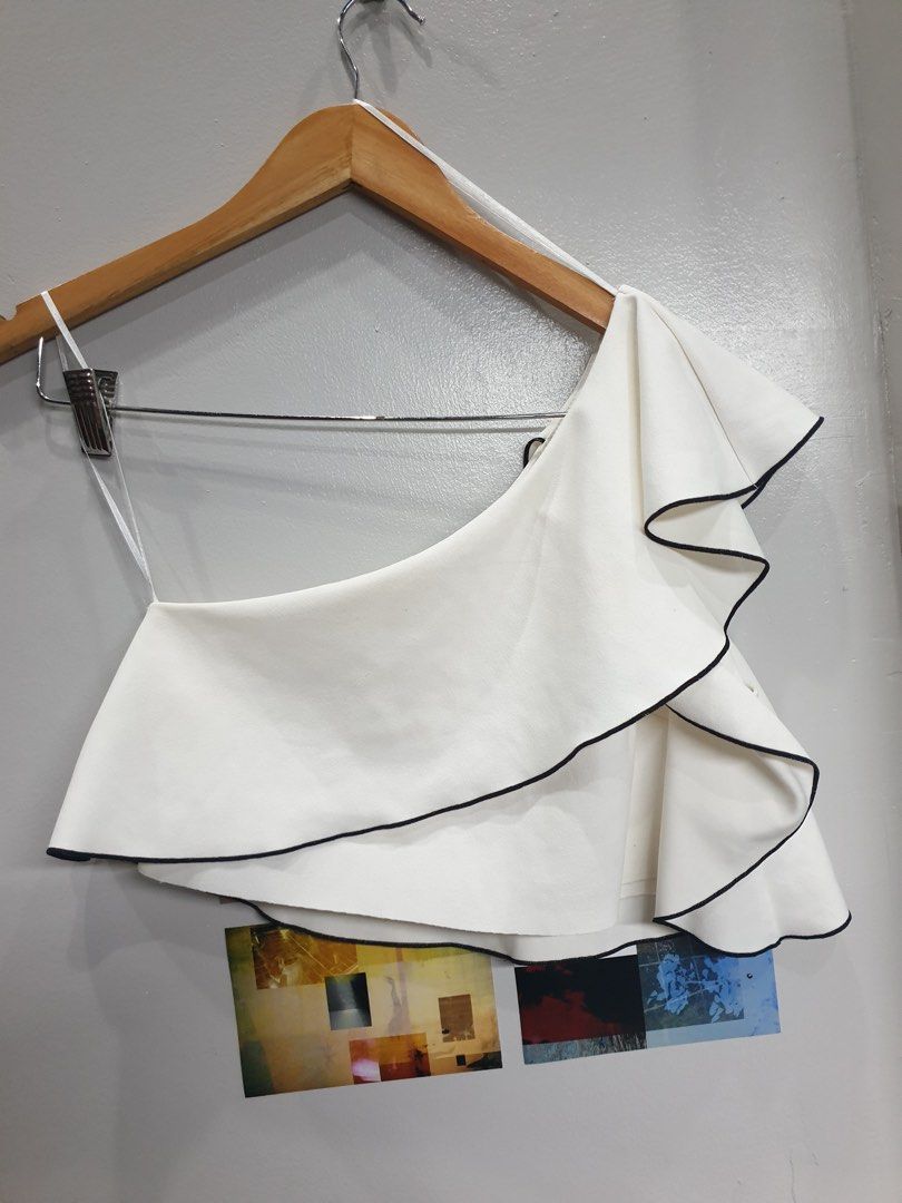 Zara white one-shoulder asymmetrical crop top (Category: Others Tops) located in Calamba. Submitted by mimabuy (Listing ID 1467389026, Image 1). Description: Super pretty! Small on tag but can still fit medium frames Honest Issue: one small dot at the back check last pic for reference Other than that it’s still in good condition .