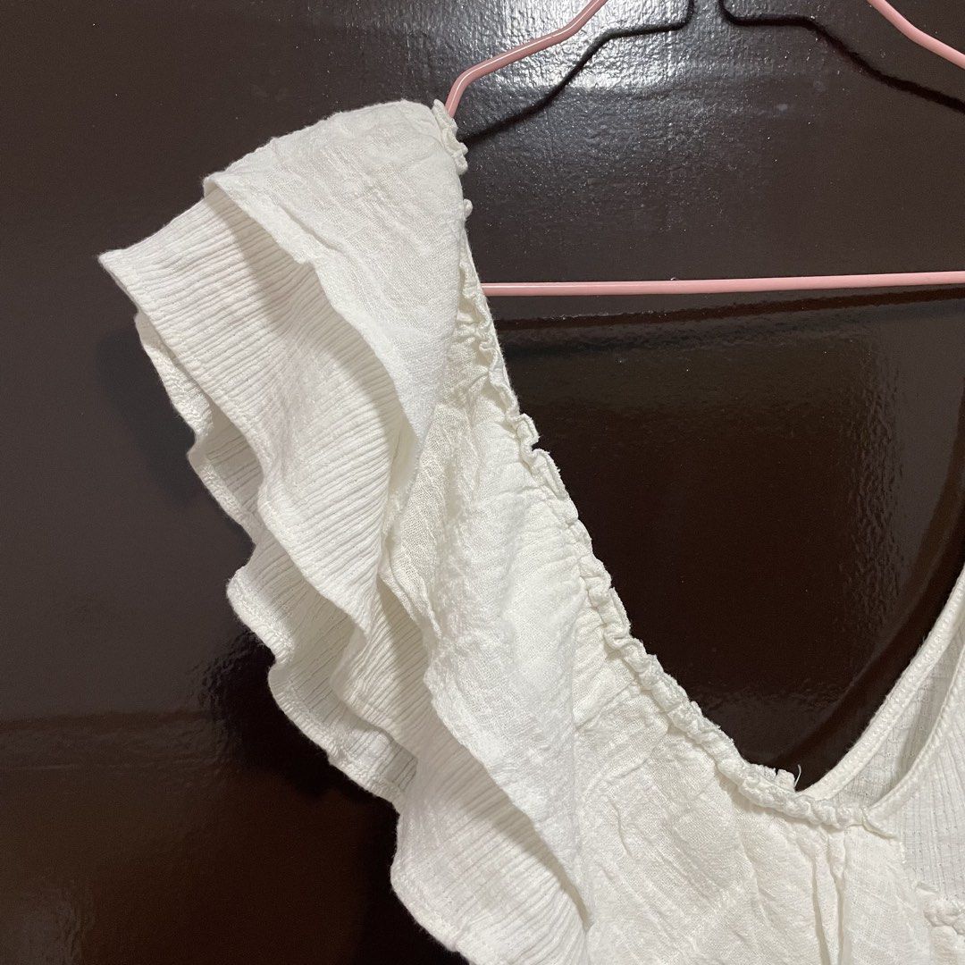 Zara White Ruffled One-Shoulder Crop Top (Category: Sleeveless) located in Pasay City. Submitted by lovedbyzea (Listing ID 1467526049, Image 3). Description: - Brand: Zara - Size: Small (S) - Color: White - Design: One-shoulder with layered ruffles and single spaghetti strap - Material: Textured ribbed fabric with elasticized hem - Origin: Made in Morocco - Condition: Great, worn only a couple of times.