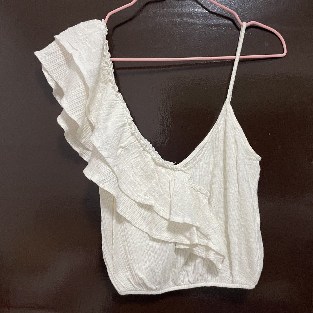 Zara White Ruffled One-Shoulder Crop Top (Category: Sleeveless) located in Pasay City. Submitted by lovedbyzea (Listing ID 1467526049, Image 2). Description: - Brand: Zara - Size: Small (S) - Color: White - Design: One-shoulder with layered ruffles and single spaghetti strap - Material: Textured ribbed fabric with elasticized hem - Origin: Made in Morocco - Condition: Great, worn only a couple of times.