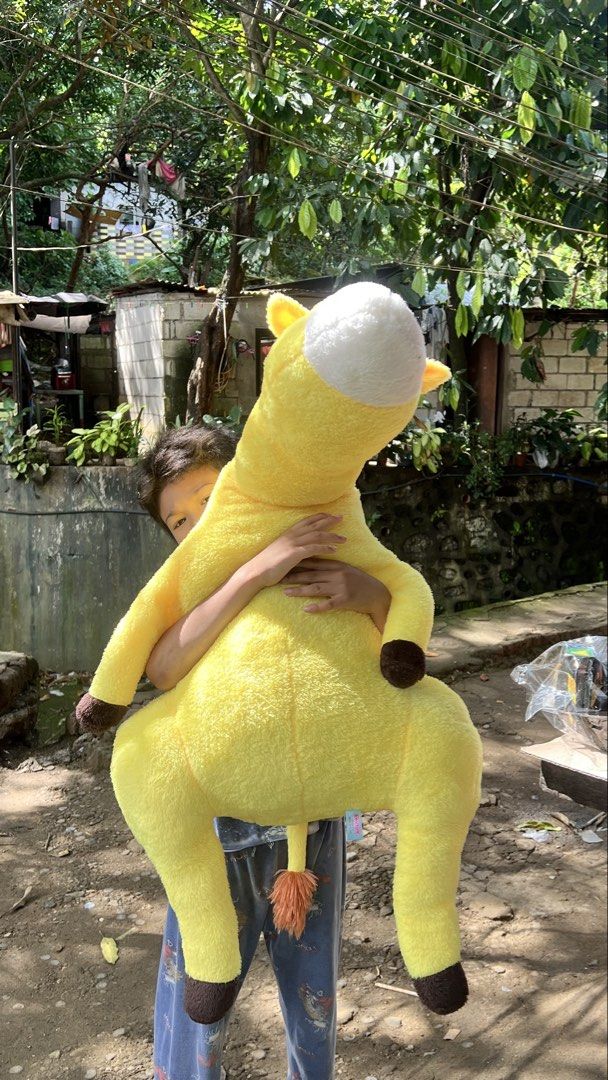 110cm Large Yellow Giraffe Stuffed Toy Plush (Category: Plushies & Soft Toys) located in San Jose del Monte. Submitted by faithyfairy_ (Listing ID 1467718974, Image 2). Description: - Big yellow giraffe plush toy - Super soft and fluffy material, great for hugging - Features brown patches, a long neck, orange tail end, and brown hooves - Clean and well-maintained condition.